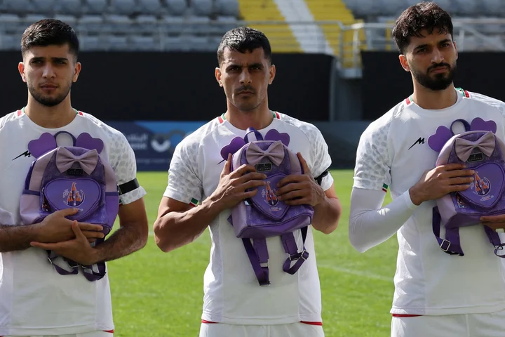 Iran footballers pay tribute to victims of school strike at start of war