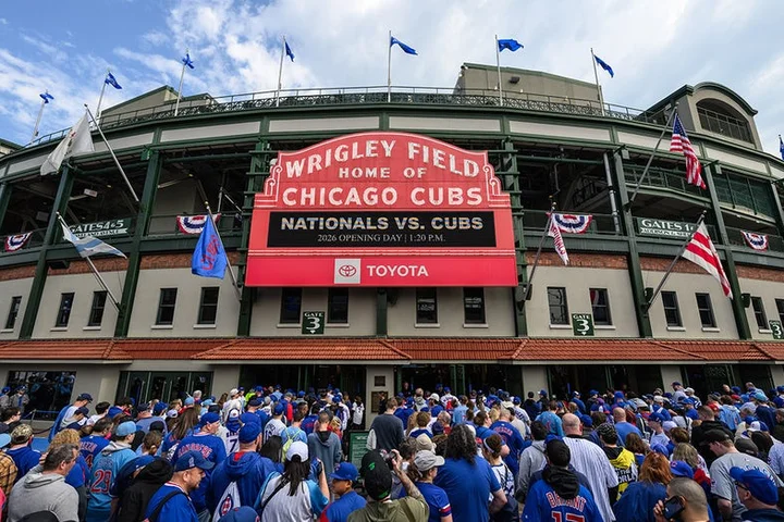 Fan spotted with laptop, apparently logging work hours from Wrigley Field stands during Cubs day game