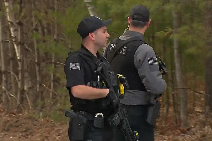 Massive manhunt underway in New Hampshire town after gunman allegedly wounds police officer, fires on family