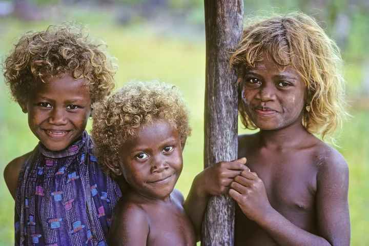 Dark-skinned people with blonde hair region of Oceania