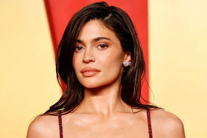 Kylie Jenner dazzles in daring white string bikini for poolside photos