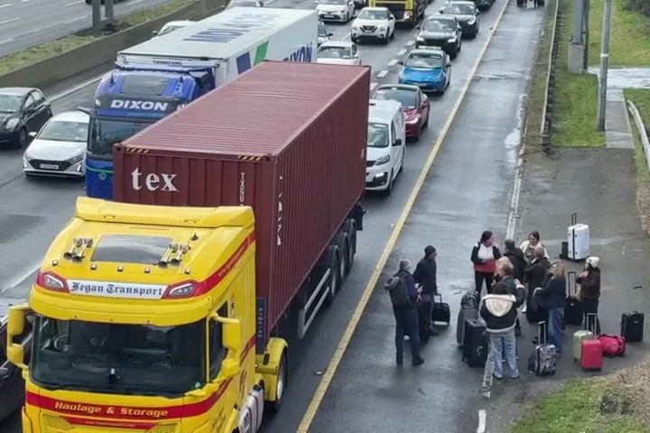 People walk along motorway towards Dublin Airport as blockade continues