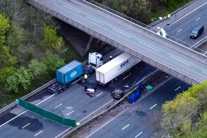 Two teens killed after car crashes off bridge and hits minibus on motorway