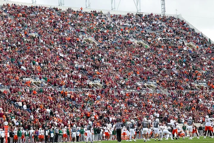 Skydiver's parachute gets stuck on scoreboard at Virginia Tech spring game in harrowing scene