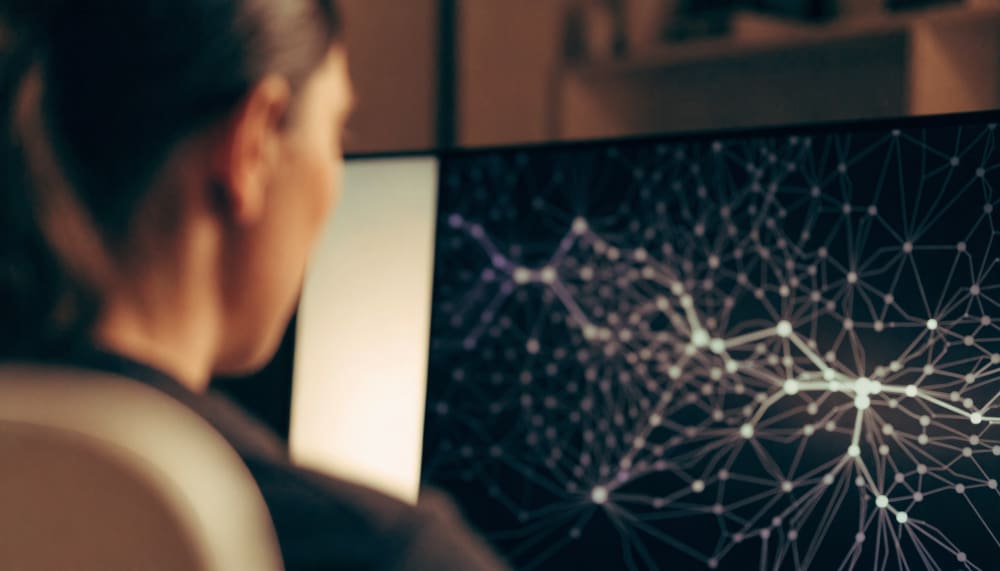 An automation builder canvas viewed over a person's shoulder, modules connecting themselves into a branching flow while