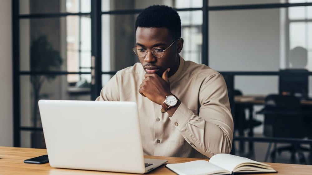 Focused Professional Black Man Working on Laptop in Office