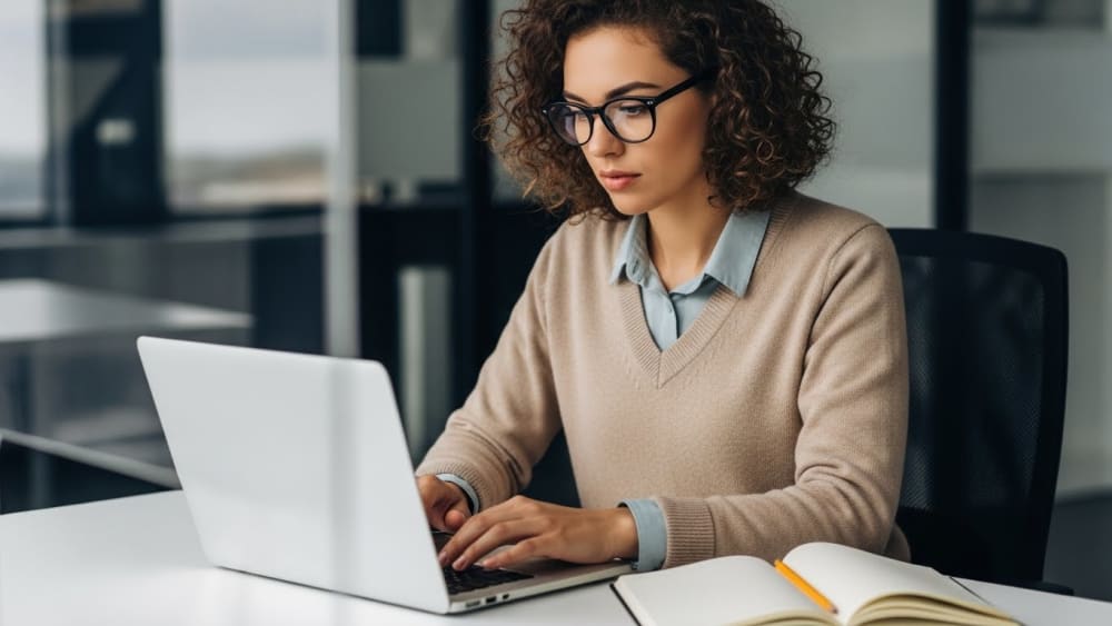 Professional Businesswoman Focused on Laptop at Office Desk