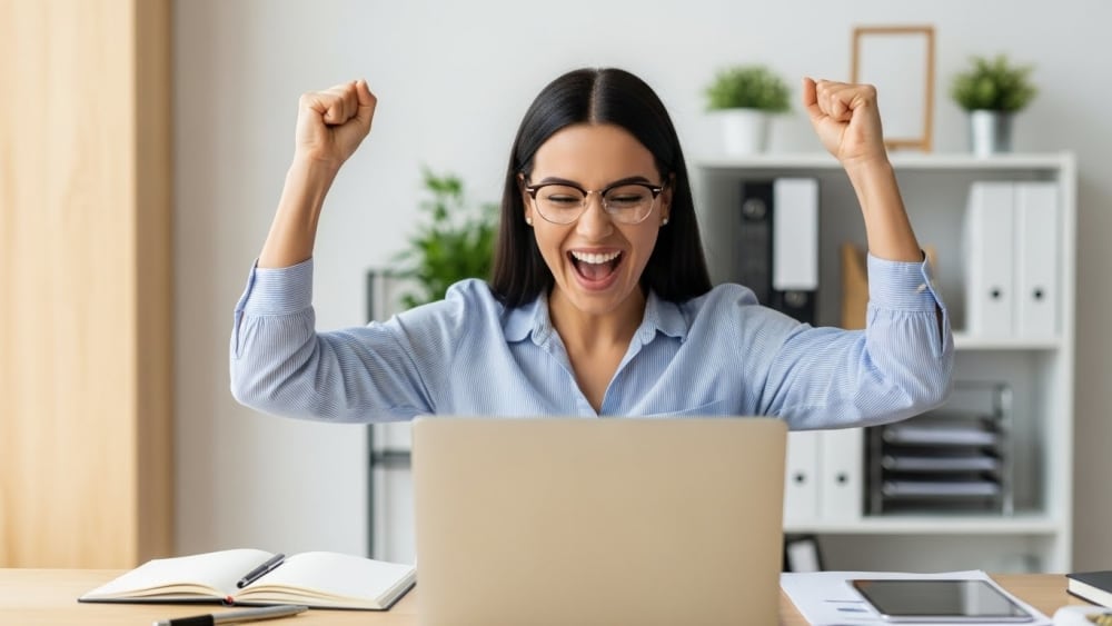 Excited Businesswoman Celebrating Success at Office Desk