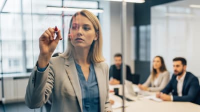 Focused Executive Planning Business Strategy on Glass