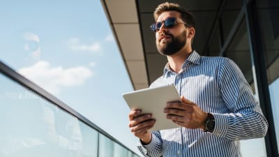 Successful Businessman With Tablet on Rooftop