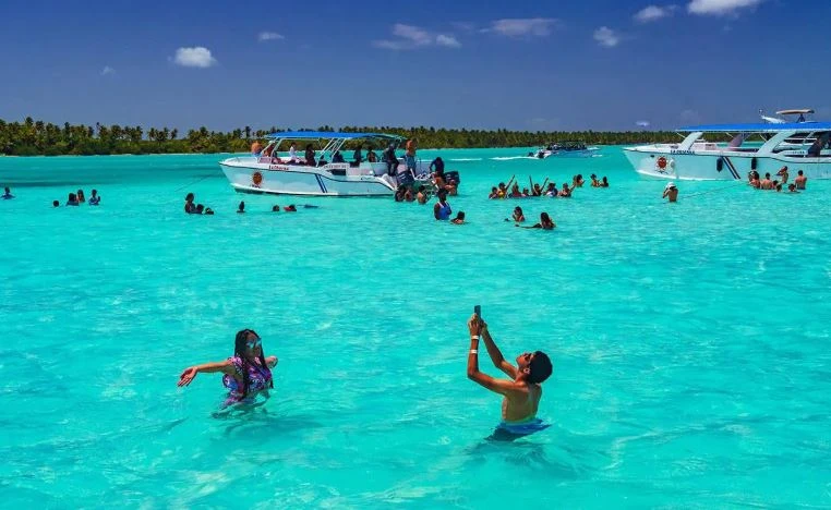 Tourists enjoying the natural pool in Saona Island