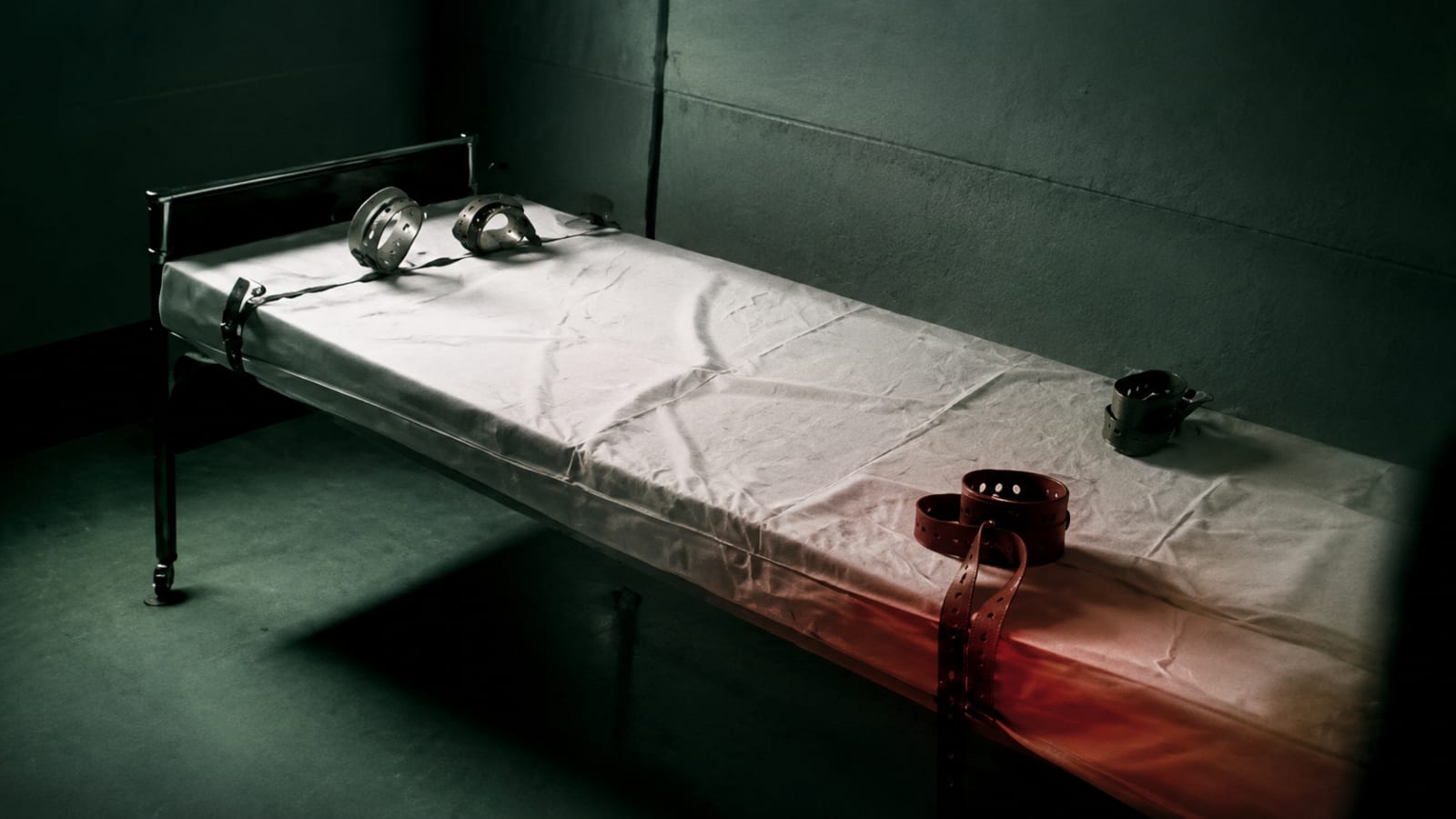 An empty bed with restraints in a psychiatric ward