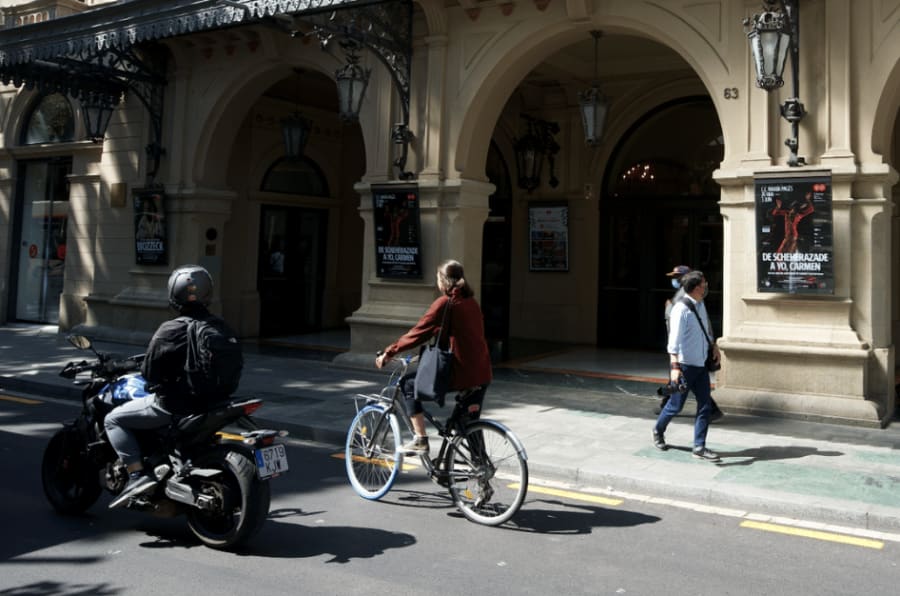 people riding a bike in barcelona
