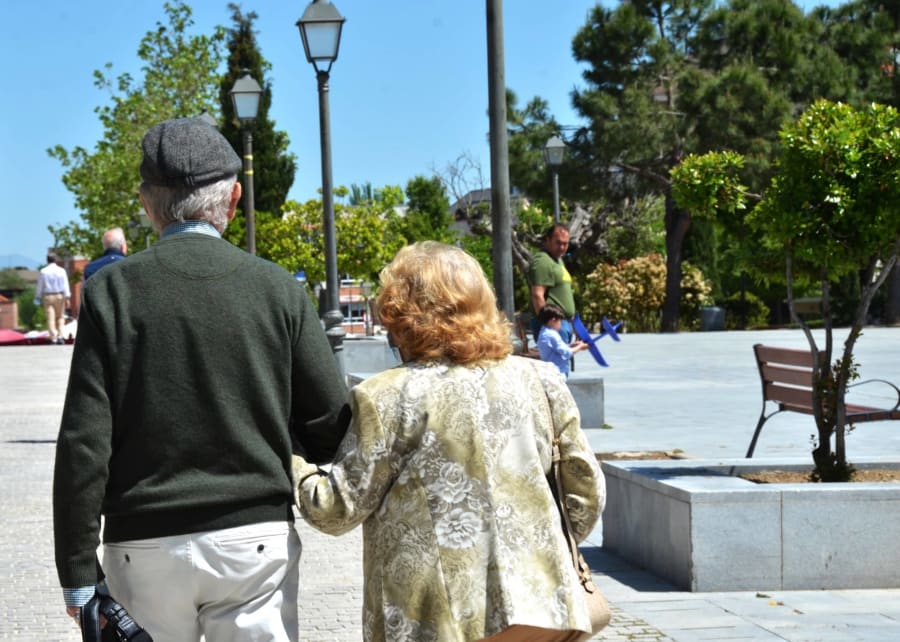 old couple spain walking holding hands
