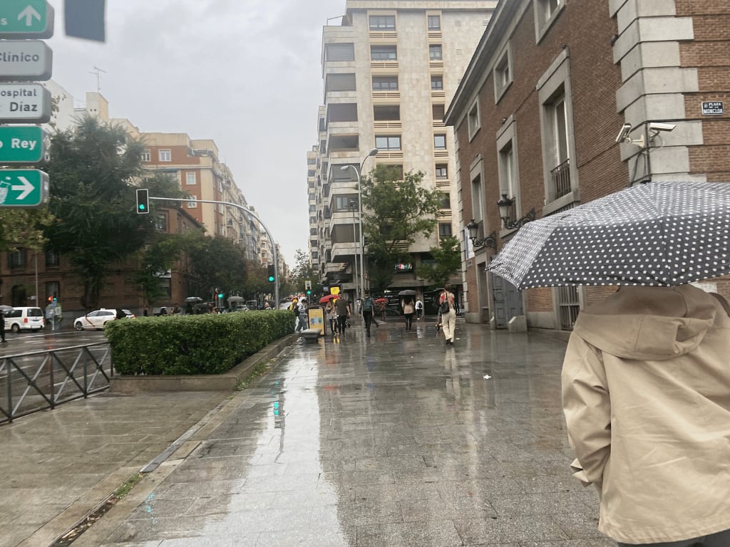 walking people with umbrellas in spain