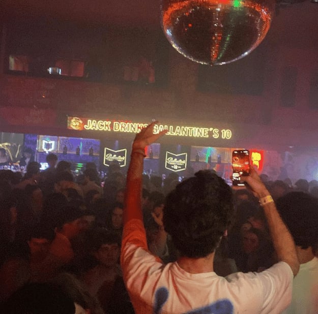 barcelona nightlife people partying hands up disco ball
