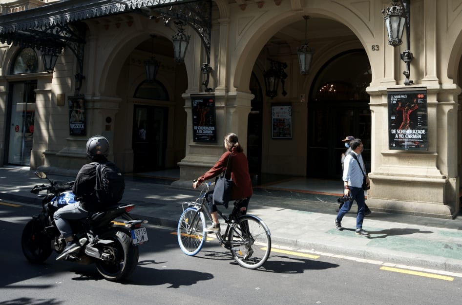 people riding a bike in barcelona