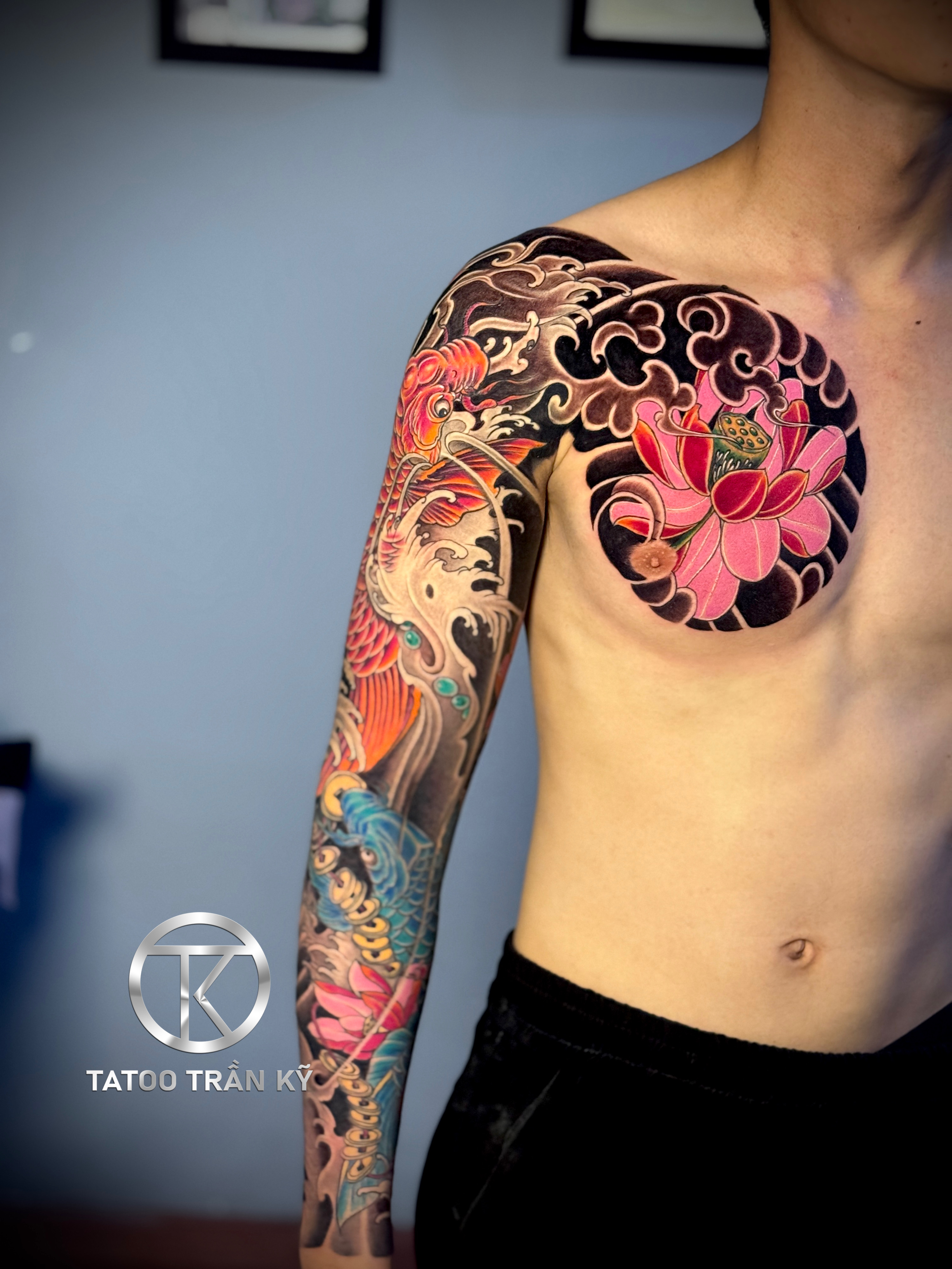 Full sleeve tattoo across the chest done by Tran Ky Tattoo