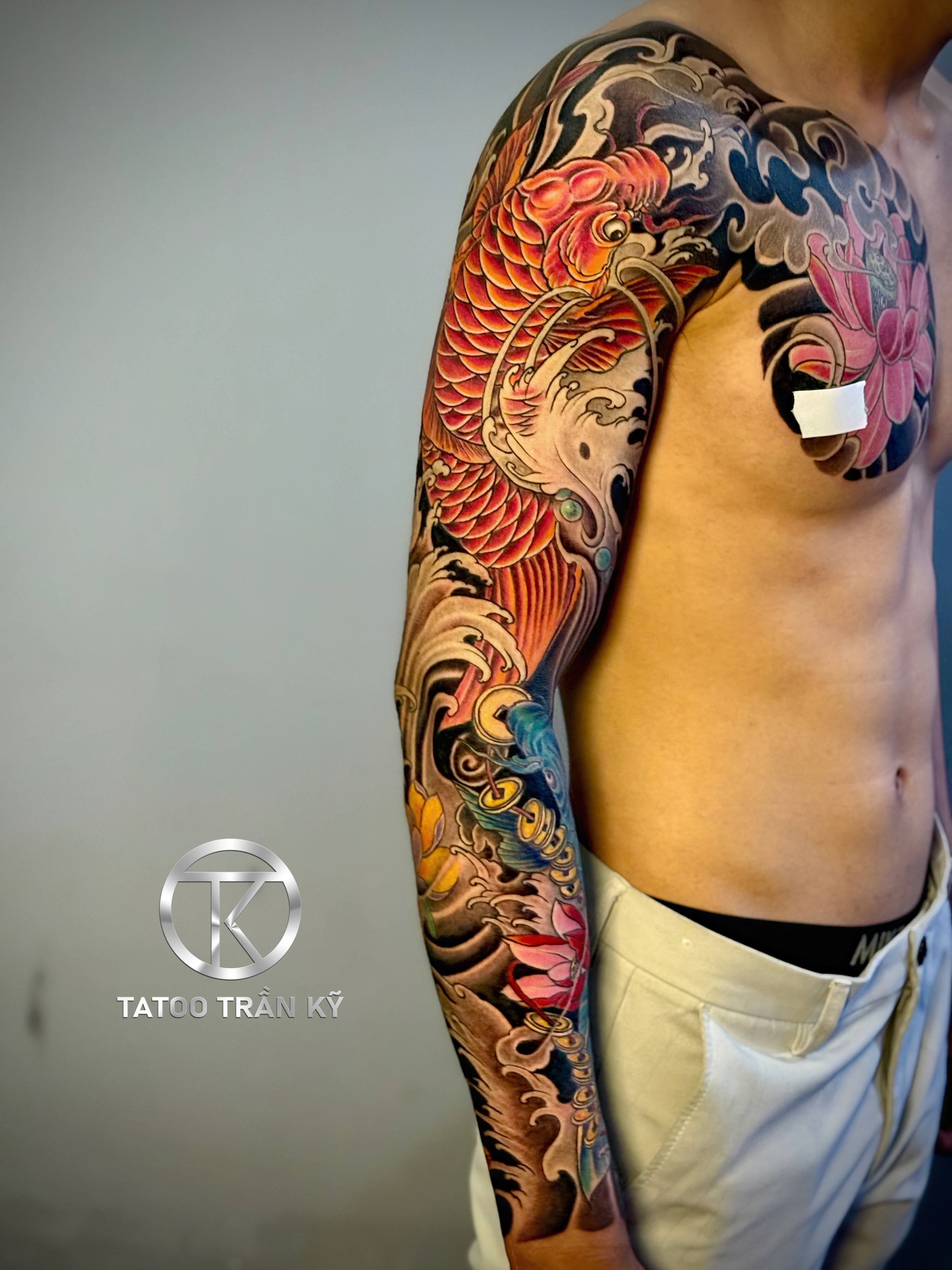 Full sleeve tattoo across the chest done by Tran Ky Tattoo - 2
