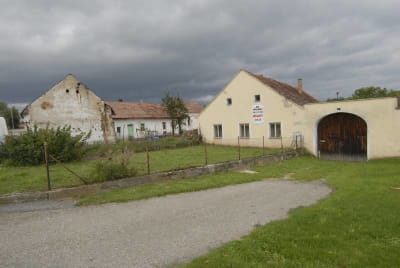 Mirkovice, vjezd a  dům usedlosti čp. 2, v pozadí část usedlosti čp. 1, síň, roubená obytná místnost se zděnou plentou, (dřevo smítáno v letech 1422 - 1430, dendrochronologie  Tomáš Kyncl) a část špýcharu