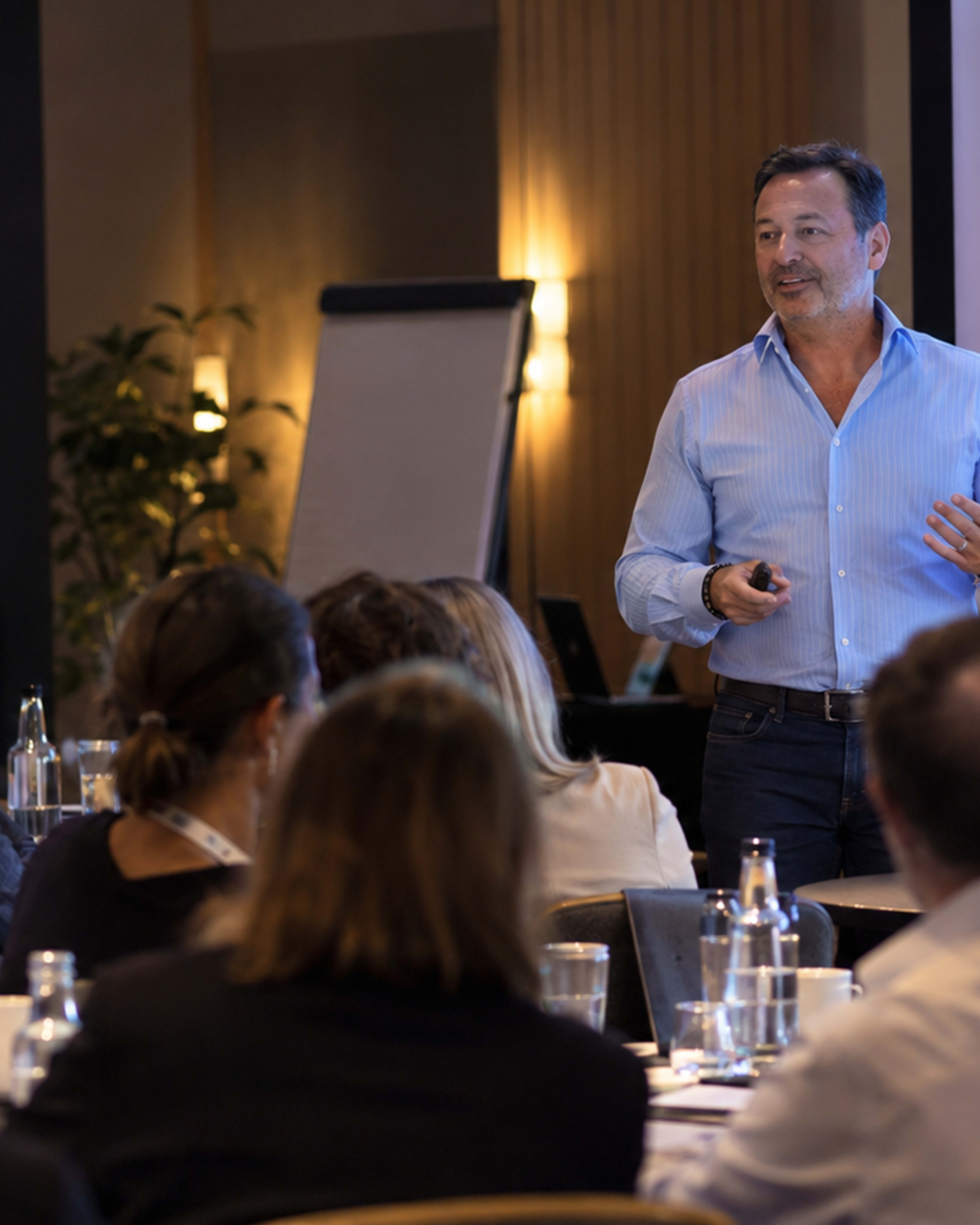 Rick Snyder leading a workshop with a room of participants.