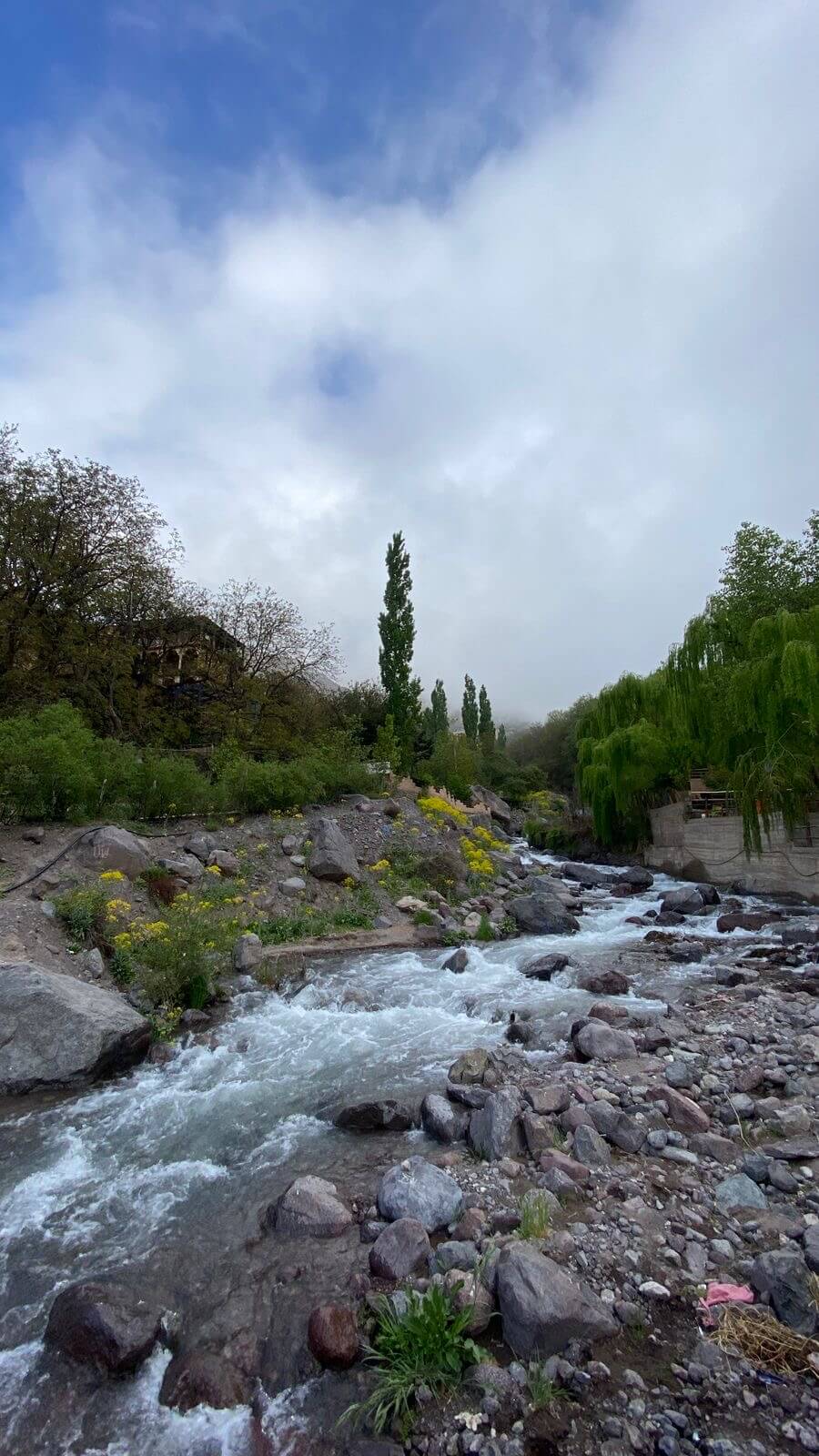Panoramic Imlil Valley trail with terraced fields and High Atlas mountain backdrop