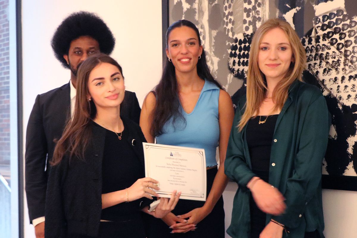 Student receives BAC-recognised certificate at the Oxford Summer Program graduation ceremony after Oxford ball, accompanied by residential deans Lucy Aithson, Helena Glasfow, and Jonathan—ensuring student care and wellbeing.