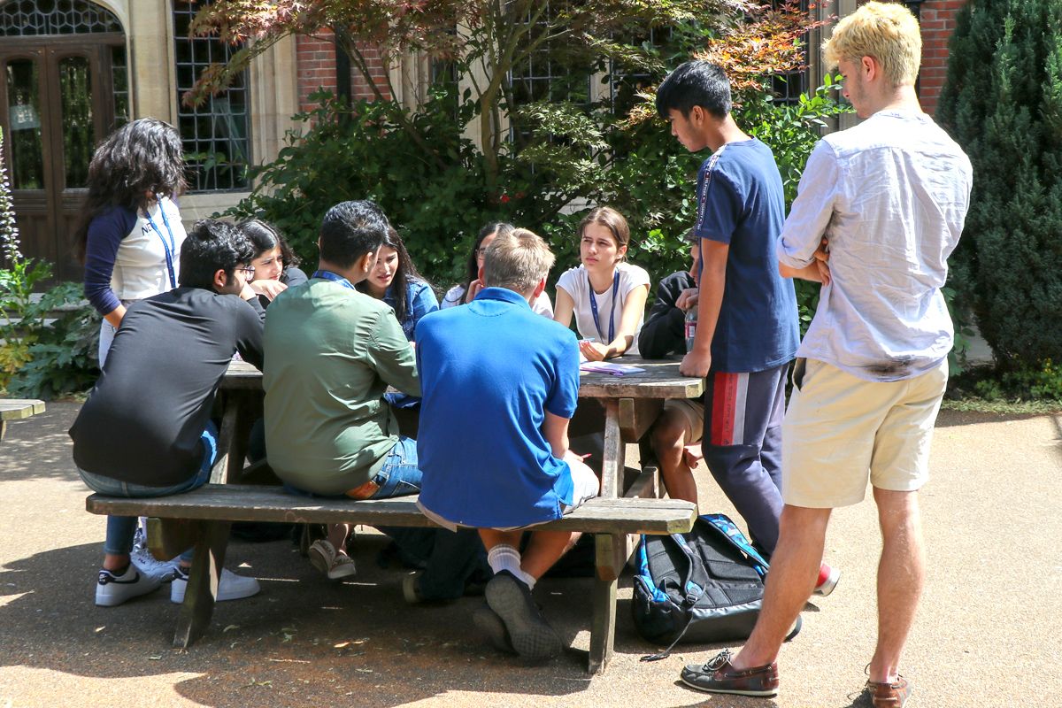 Oxford Summer Program students sit with Charlie Mackintosh, Oxford Union President (Hilary Term 2023), outside the historic Oxford Union chamber—engaged in debate and public speaking coaching.