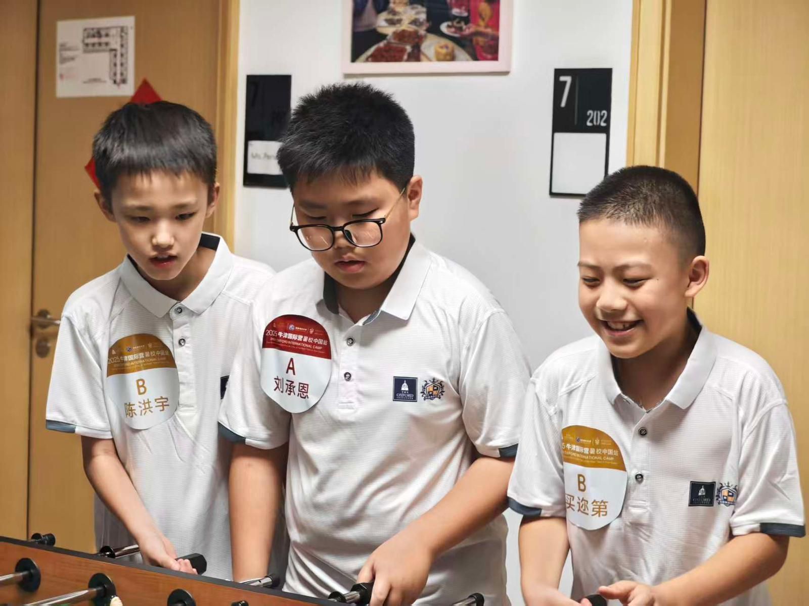 Three Chinese children aged 6, 7, and 8 enjoy playing games at Malvern College, Chengdu during the Oxford China Summer Program—a vibrant international summer experience.