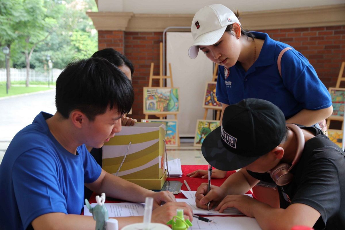 Students register at the front desk of Chengdu Malvern College for the Oxford China Summer Program—a unique, international two-week camp offering academic excellence and cultural immersion with Oxford tutors.