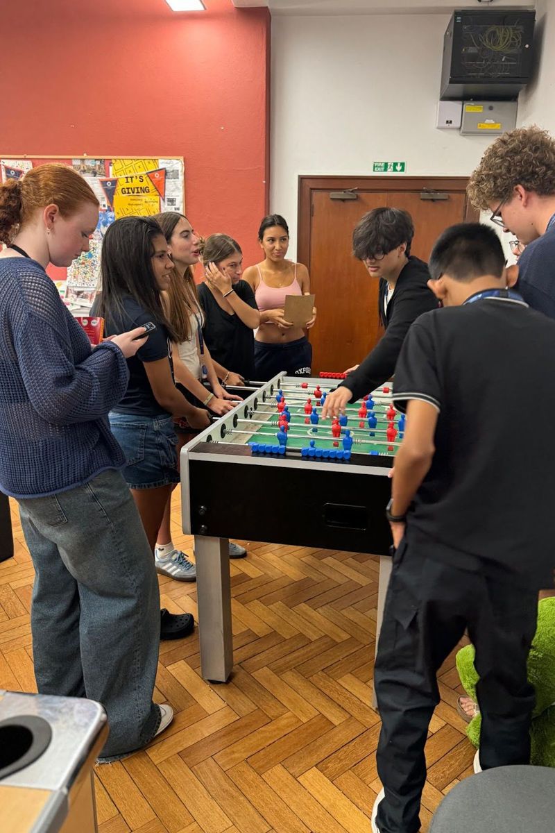 Student from the 2024 Oxford Summer Program plays indoor games at St Anne's College JCR, participating in social activities that foster community and wellbeing.