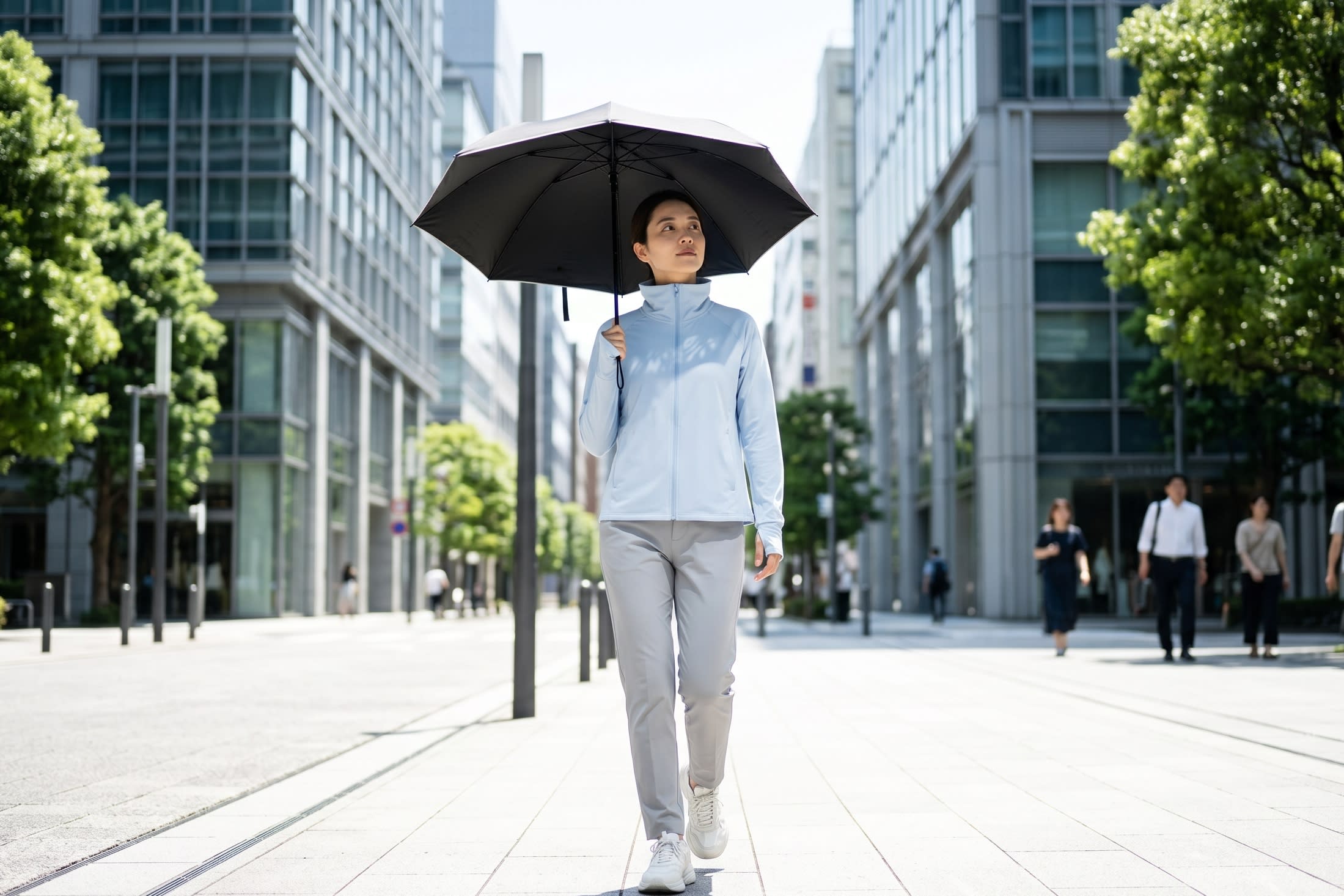 A highly fashionable woman walking down a bright, sunlit modern city street, wearing a sleek, futuristic high-collared pastel UPF sun jacket and holding a chic black-coated parasol (16:9 ratio)