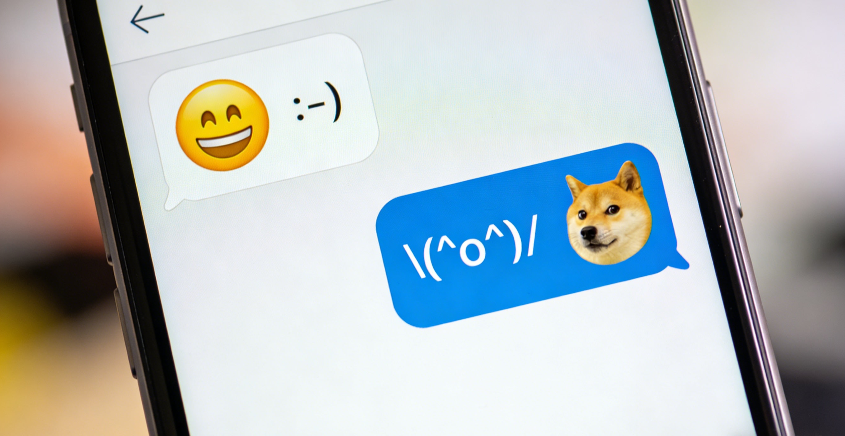 A smartphone screen showing a WeChat chat with the passive-aggressive smile emoji and the doge emoji
