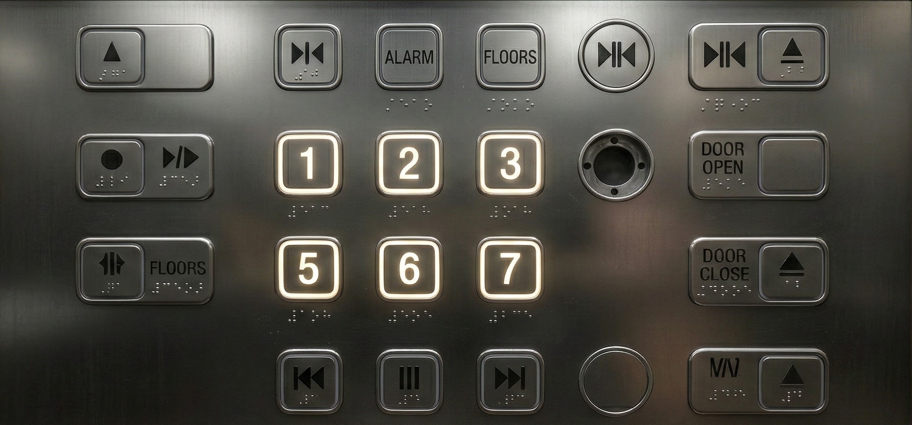 A close-up of a modern elevator button panel showing the numbers jumping from 3 to 5, skipping 4