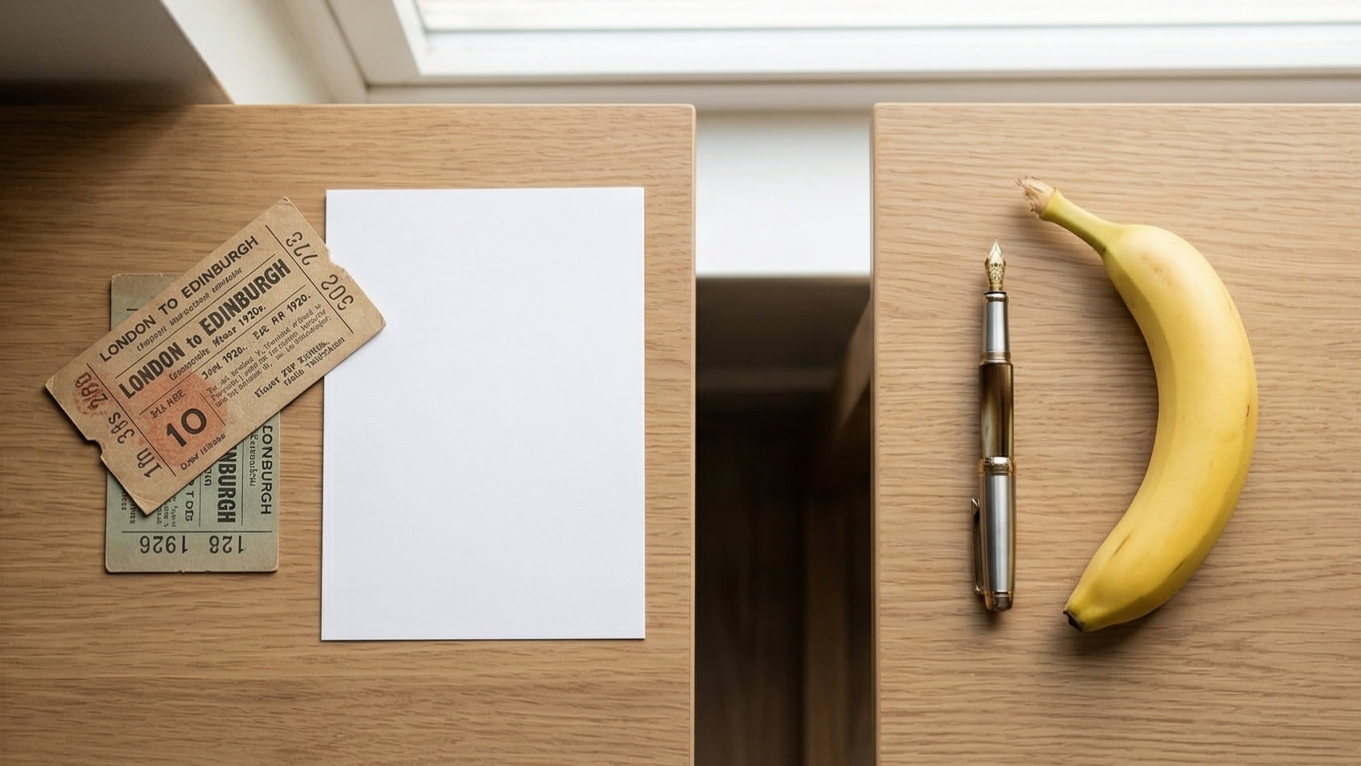 A visually pleasing flat-lay photograph on a modern wooden desk. On the left, flat items like a train ticket and a piece of paper are grouped under the character '张'. On the right, long items like a pen and a banana are grouped under the character '根'.