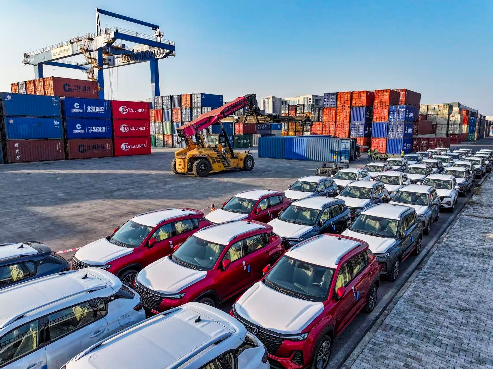 Freight train being loaded with new cars at Chongqing railway station