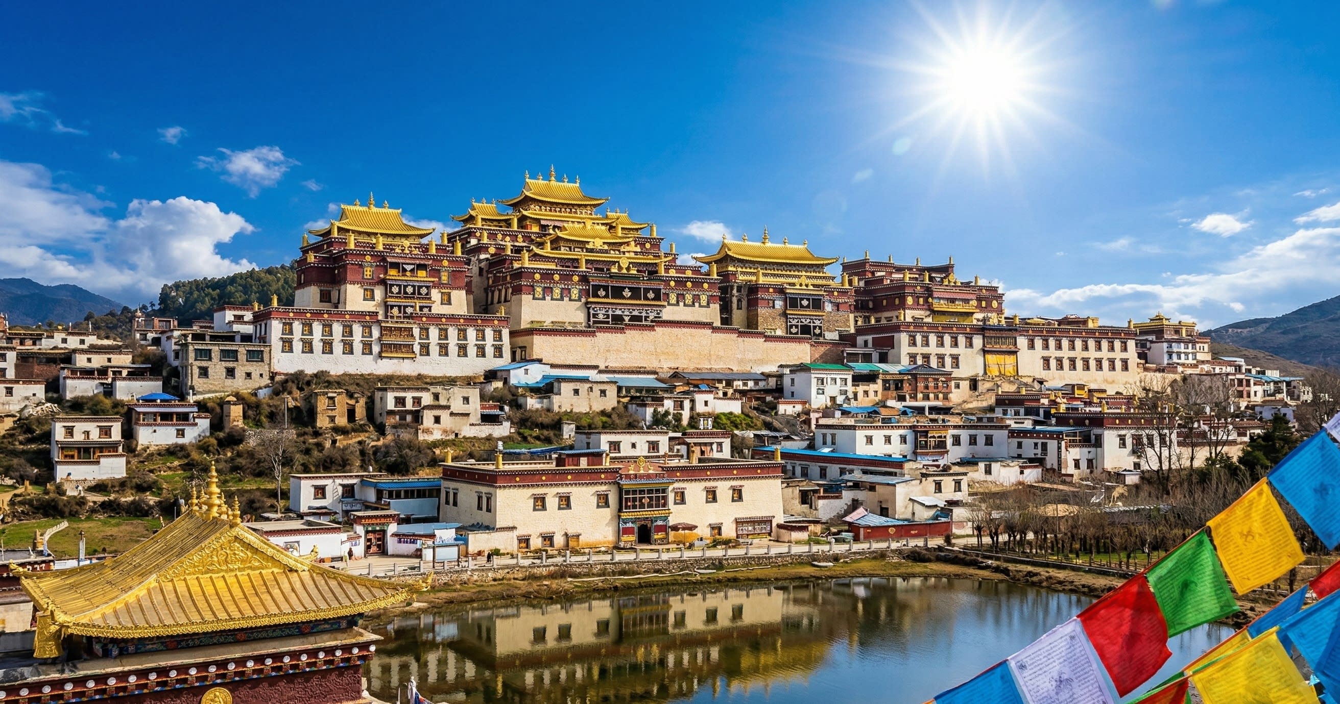 The golden roofs of Songzanlin Monastery against a deep blue sky