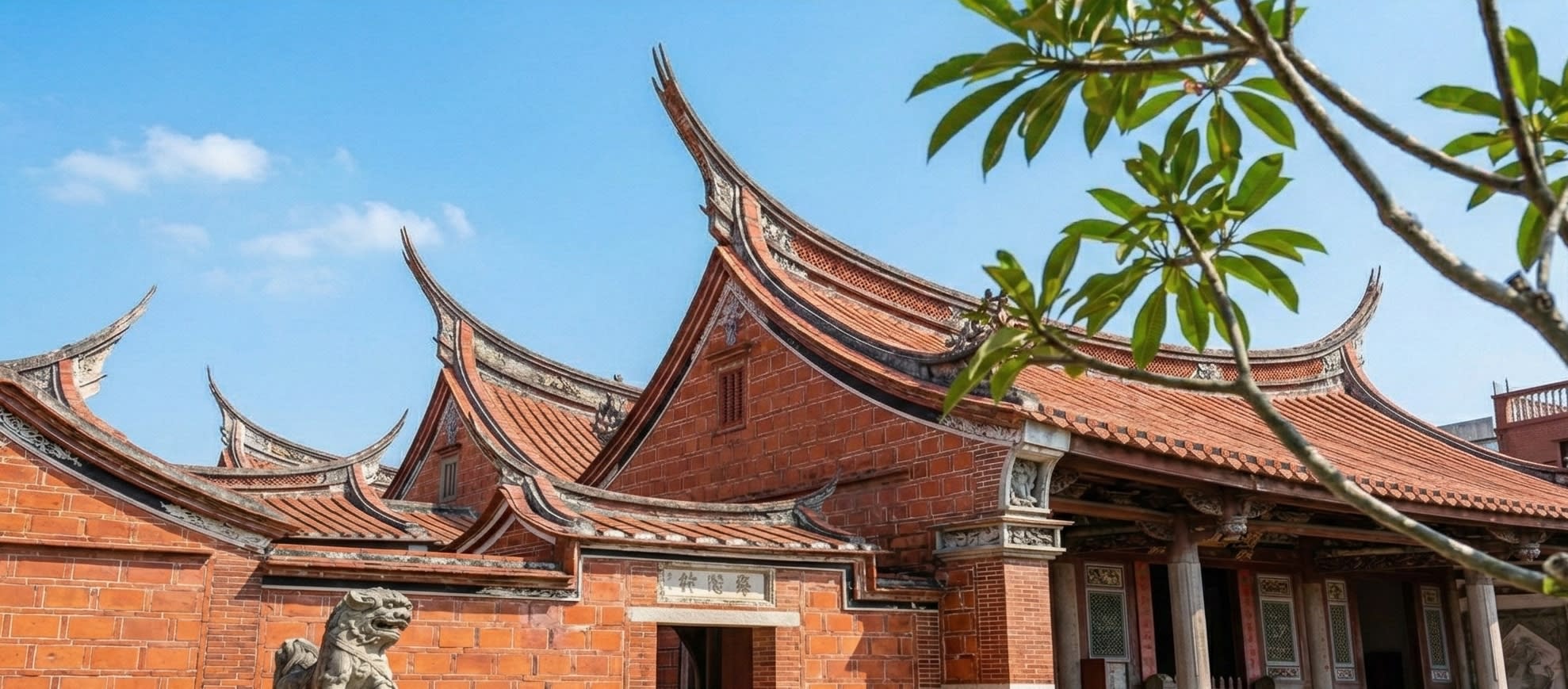 A beautiful ancient red-brick temple roof in Quanzhou with a clear blue sky