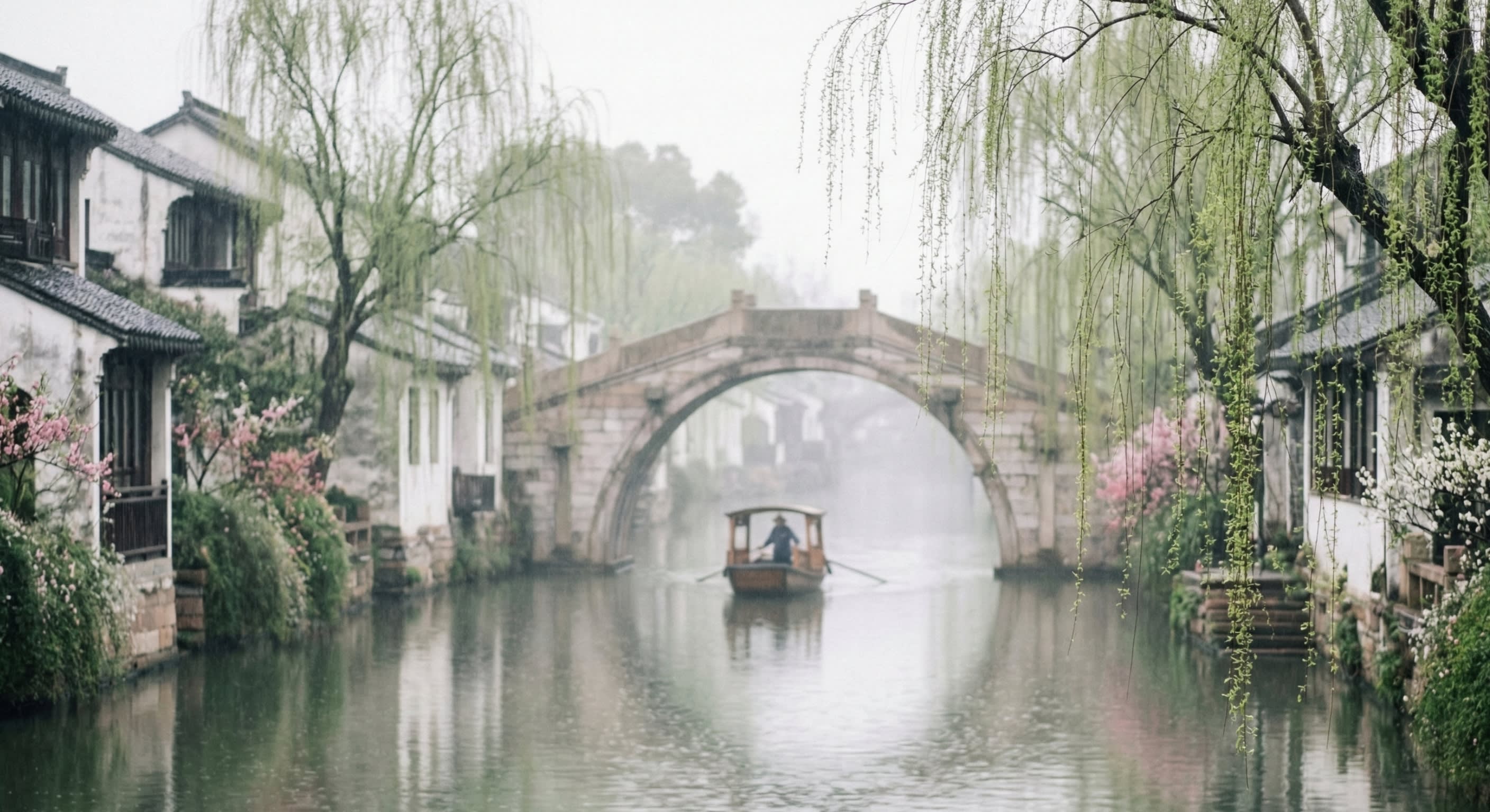 A poetic shot of a traditional Jiangnan water town in early spring with fresh willow trees and misty rain