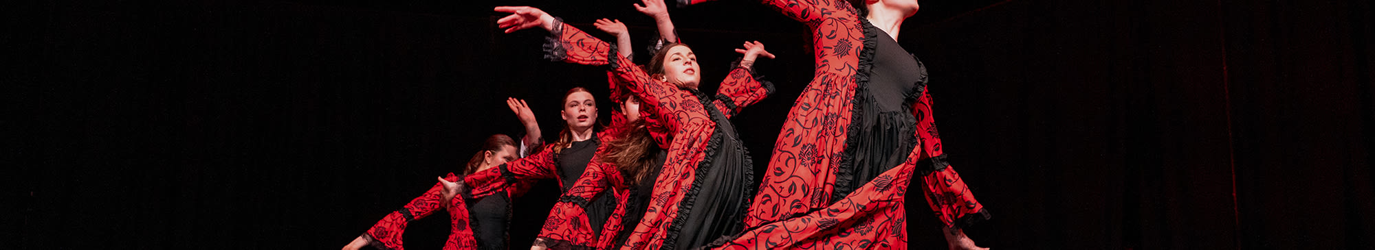 dancers performing in red and black dance costumes