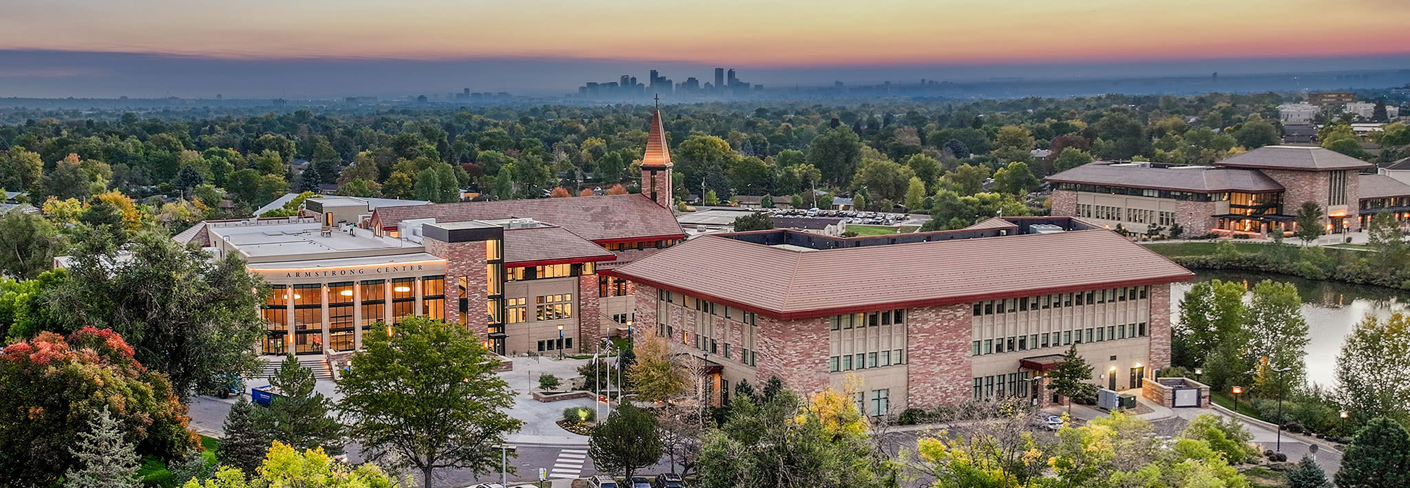 aerial view of the ccu campus with the city and mountains in the background