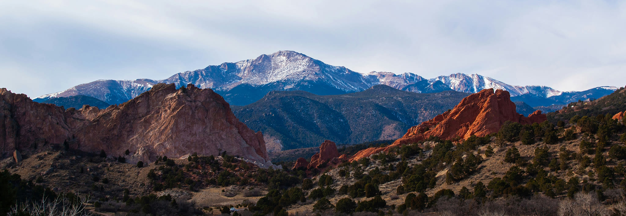 colorado mountain range with clouds around it