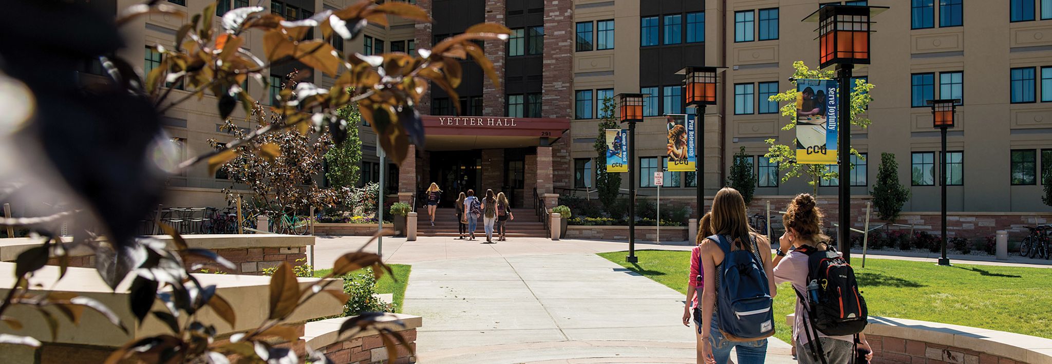 Students on walkway leading up to the entrance of Yetter Hall.