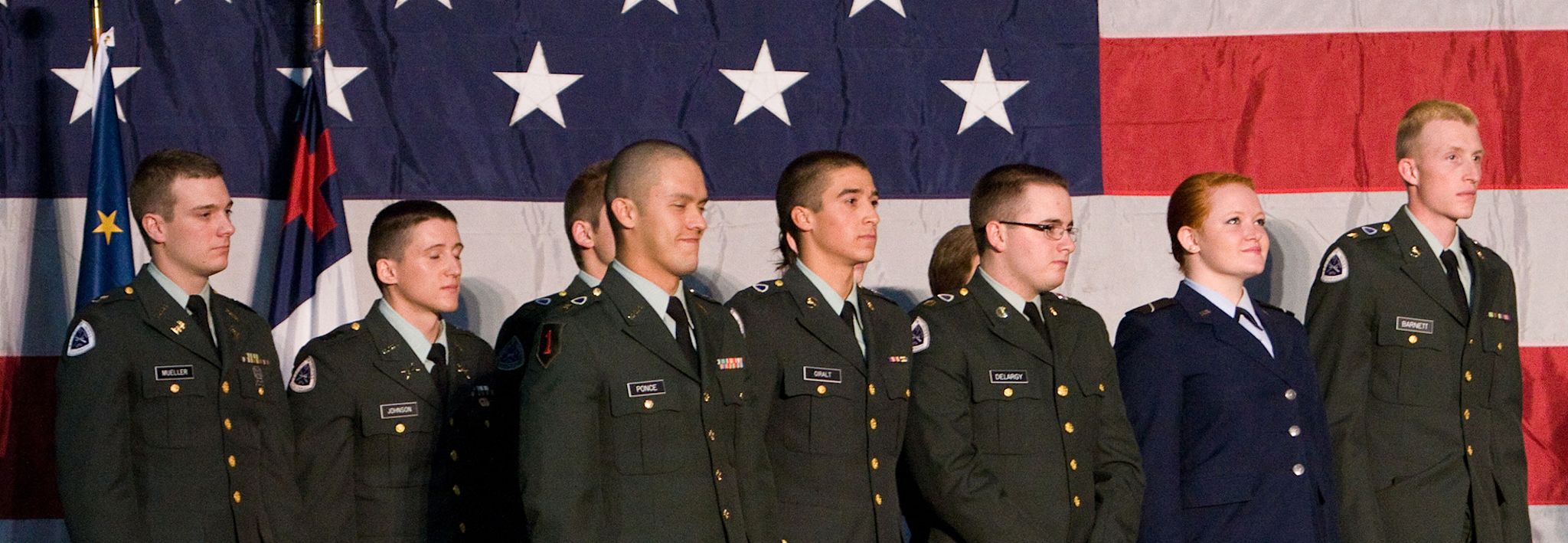 CCU ROTC Colorado Christian University students involved in ROTC pose for a photo in front of an American flag.