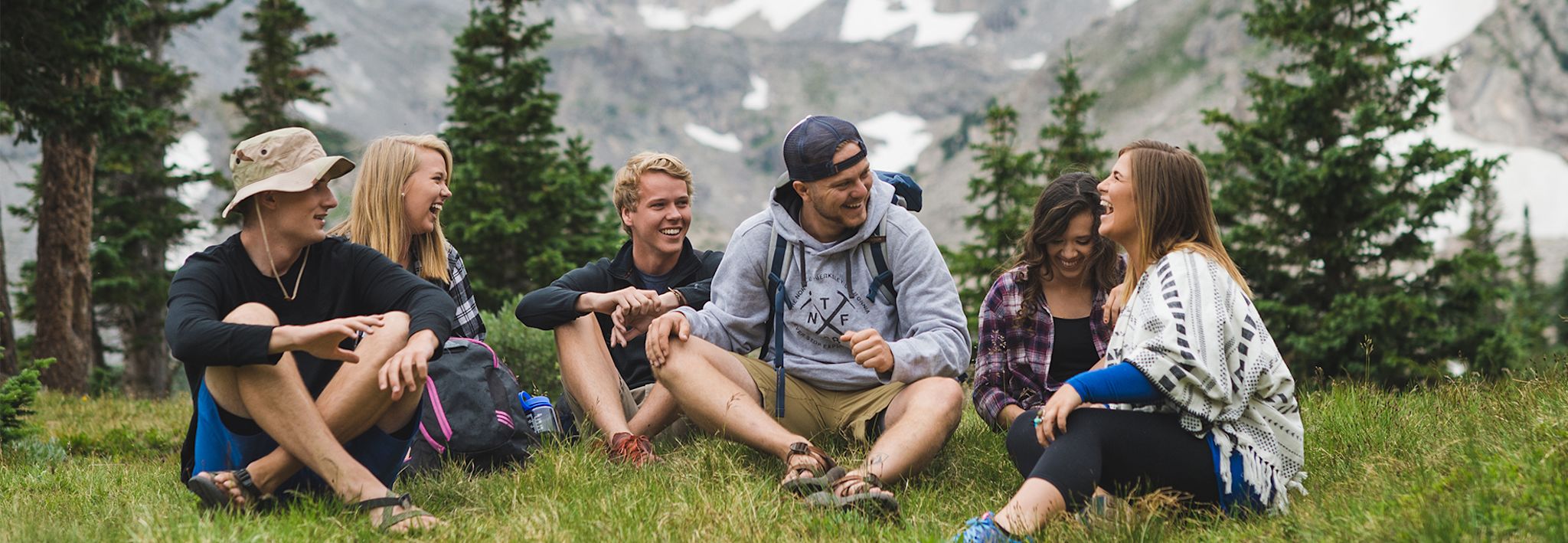 A group of CCU students sitting and chatting in the mountains of Colorado.