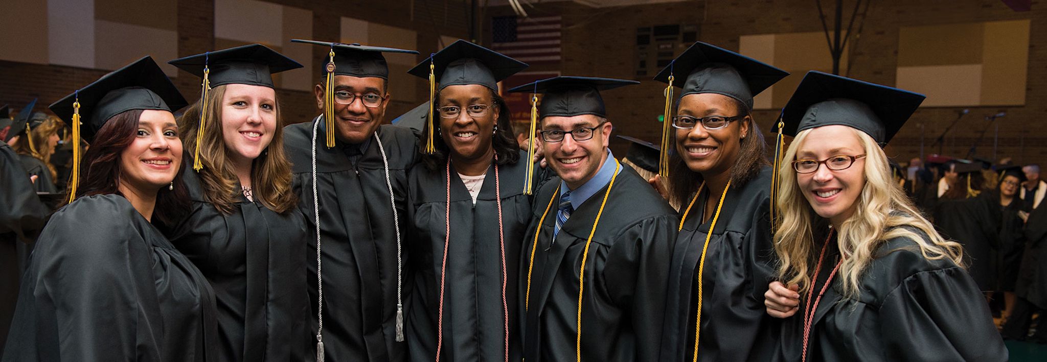 A group of CCU students is posing for a photo at graduation.