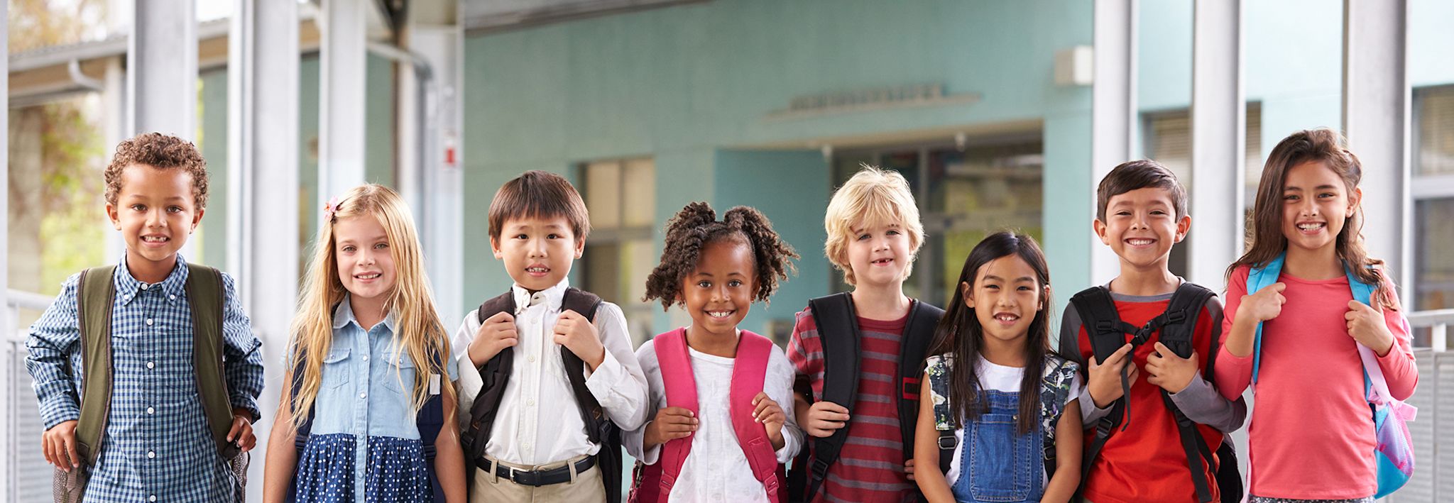 A group of children are getting ready to go into class at school.