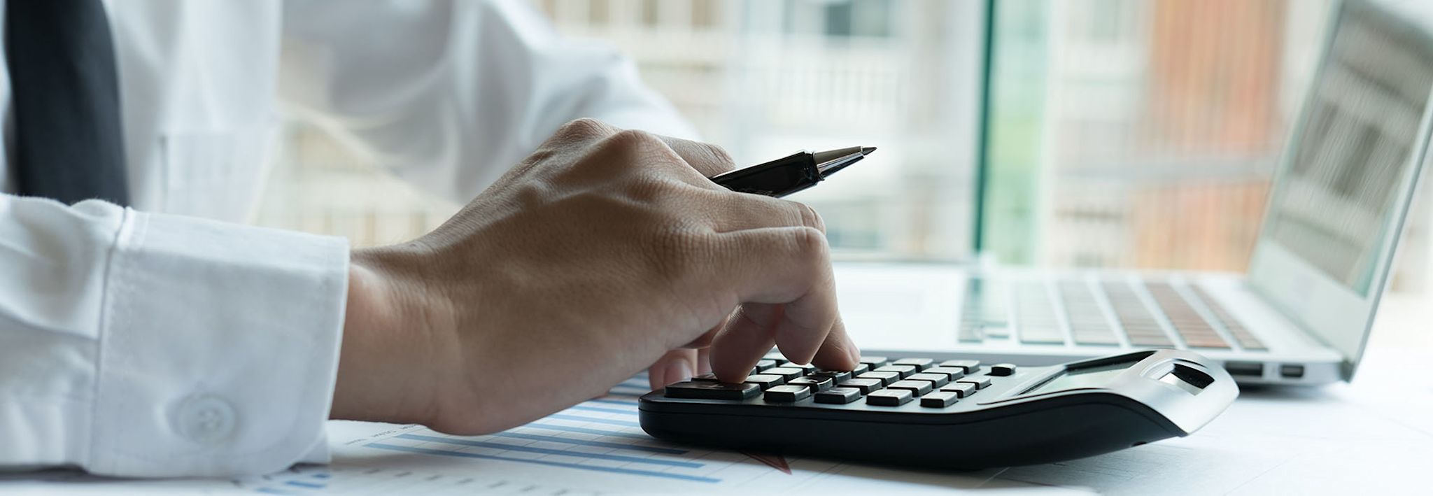 A man using his calculator to solve an equation. 