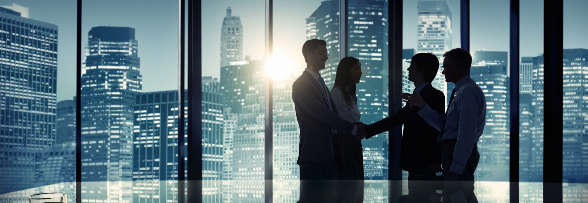Business professionals shaking hands after a successful business meeting.
