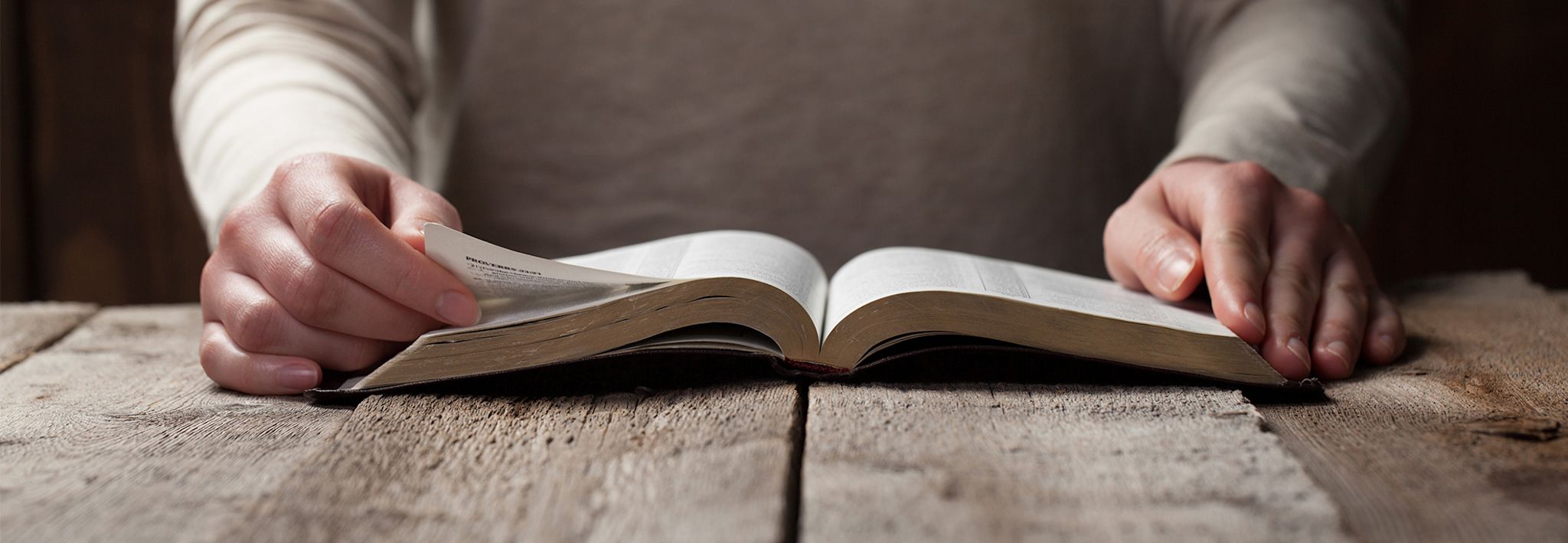 A woman has opened and is reading her Bible.